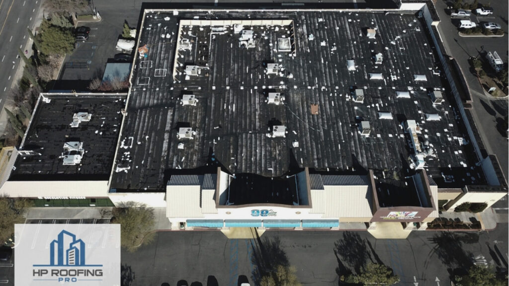 An aerial view of a white building with roof vents.