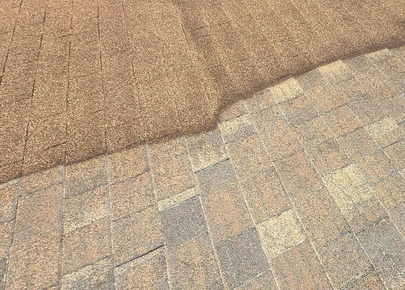 Elastomeric acrylic coating being applied over a prepared residential shingle roof