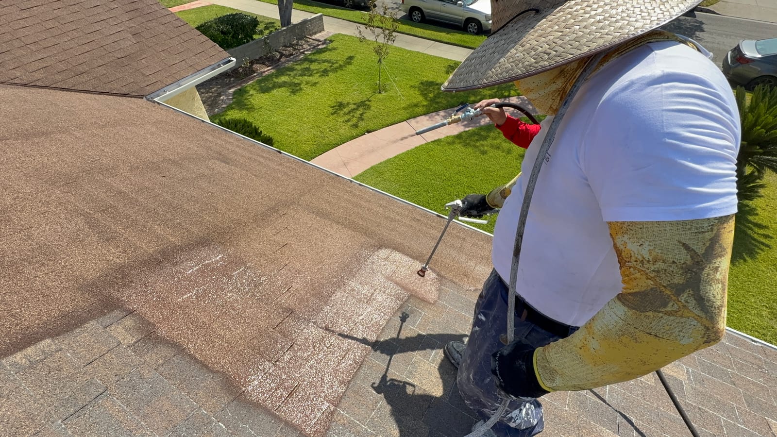 HP Roofing Pro crew applying an elastomeric acrylic coating system on a roof
